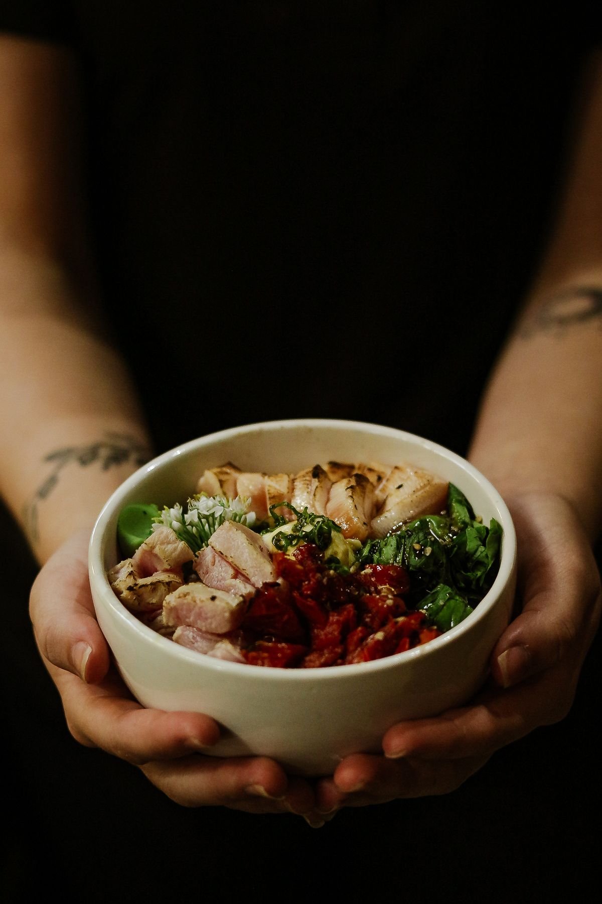 Hands holding a bowl of food